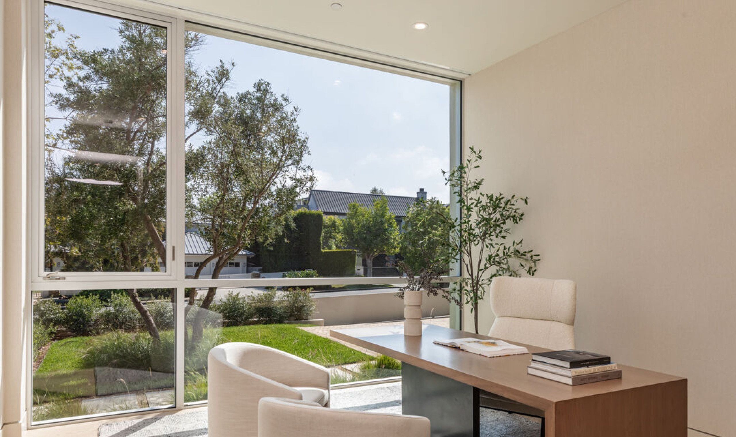 Home office with garden view through corner glazing
