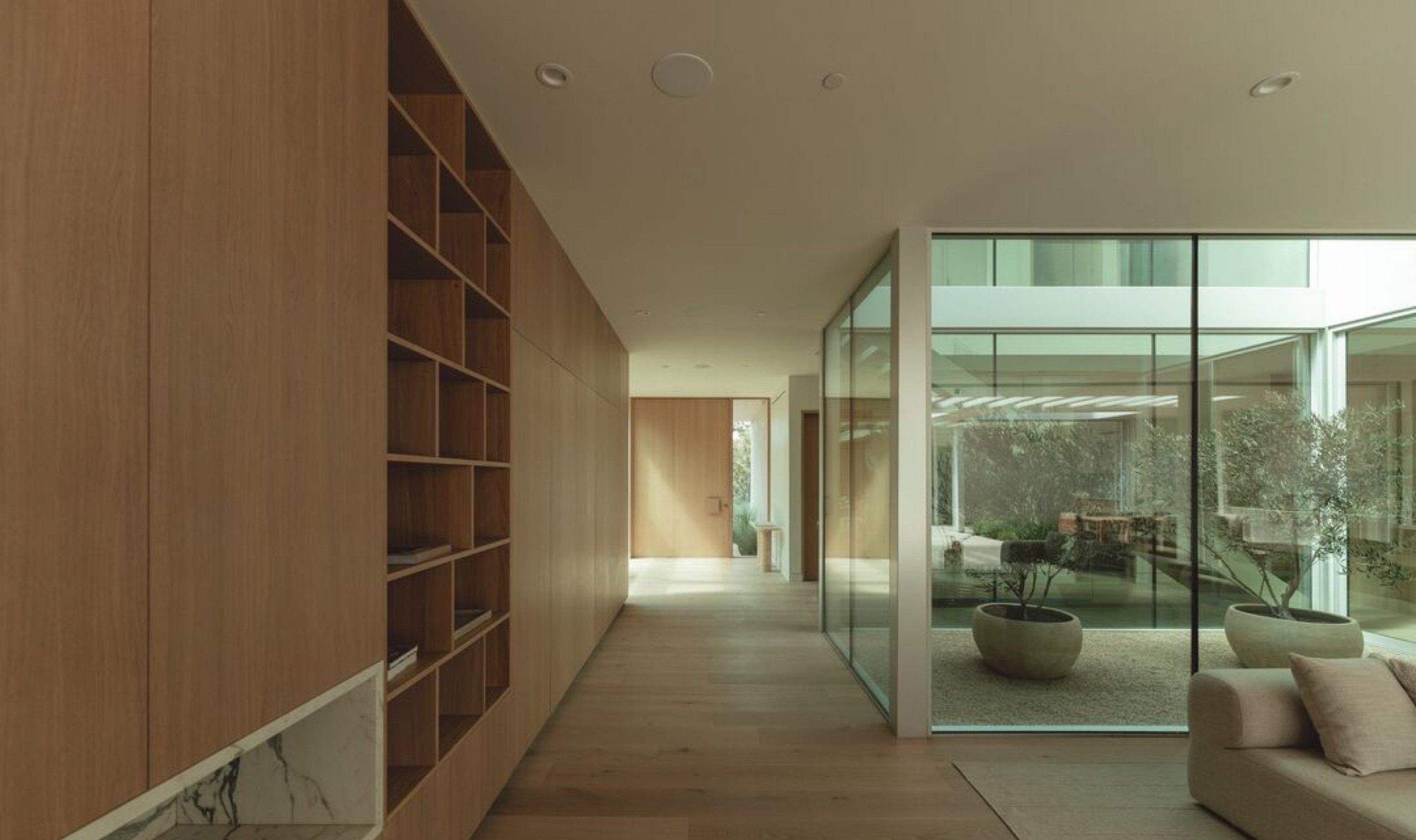 Gallery hallway with built in oak shelving