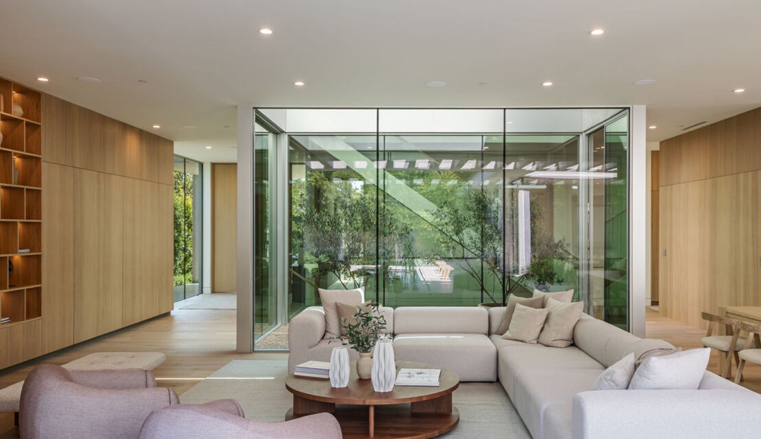 Living area beside a glass walled interior courtyard