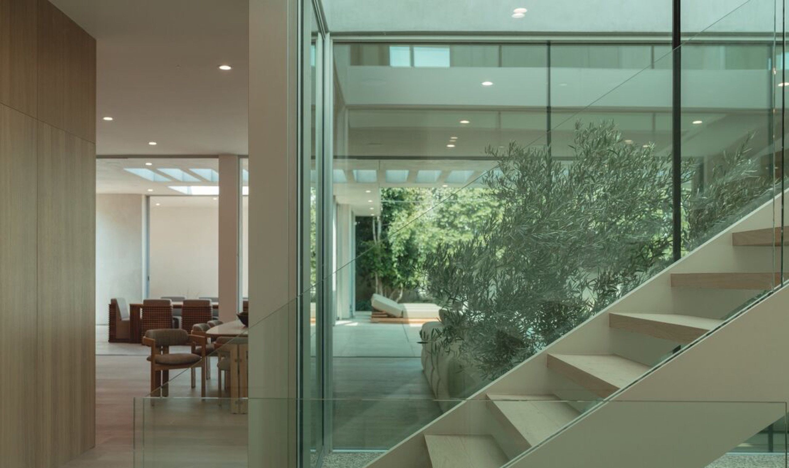Floating stair inside a glass enclosure