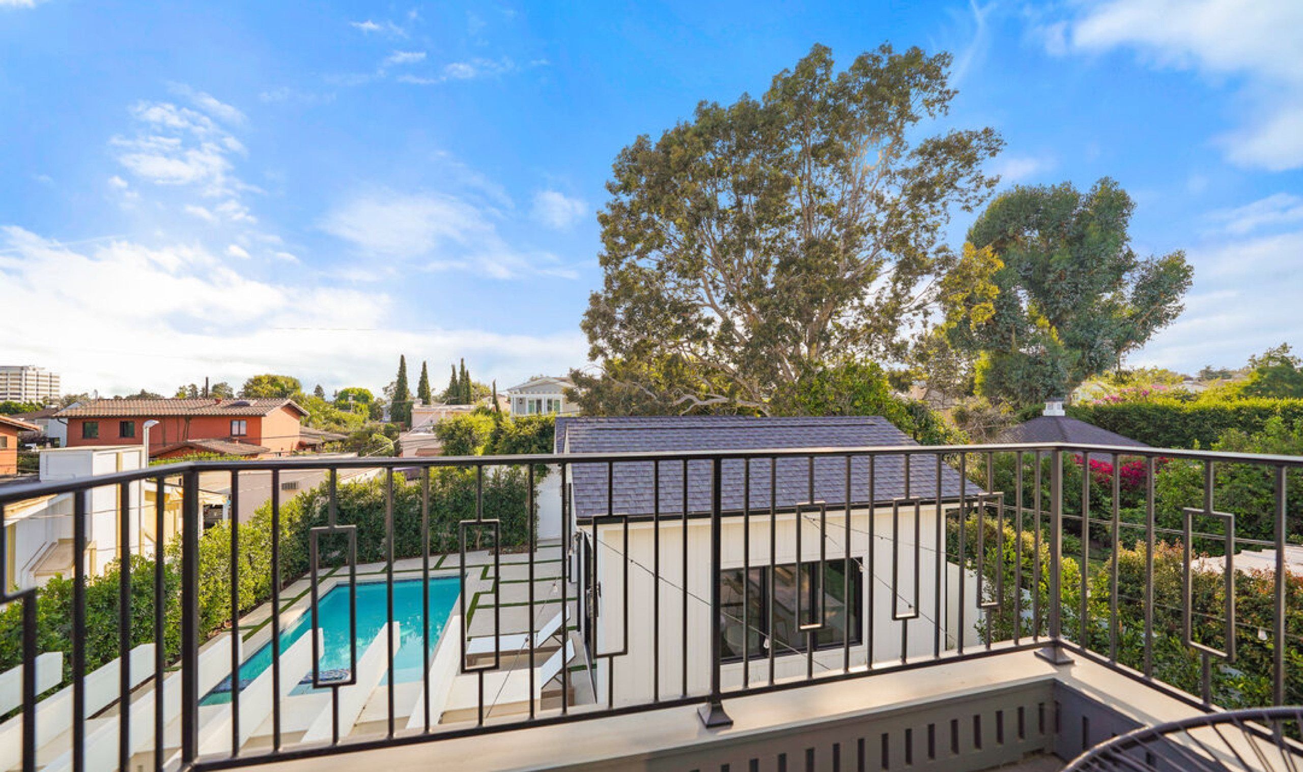 Balcony view over the pool and guest house