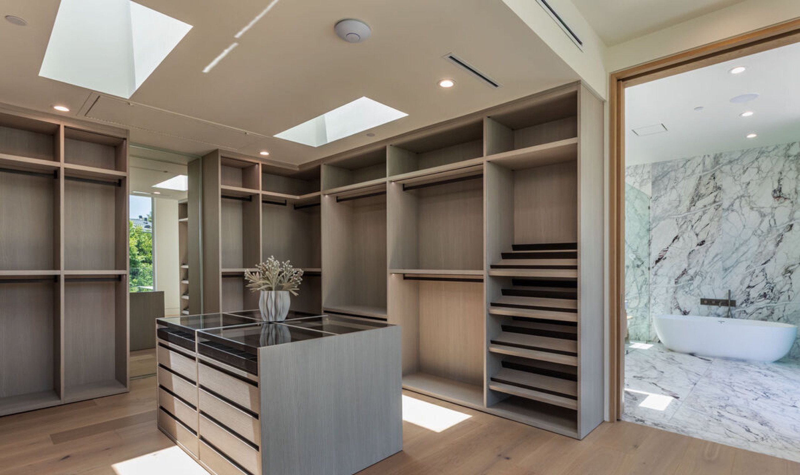 Primary dressing room with island and skylights
